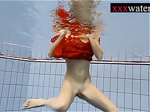 sumptuous hot damsel swimming in the pool
